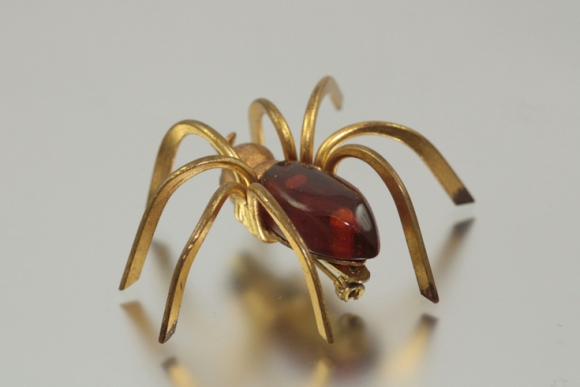 Art Deco period red galalith spider brooch - photographed by